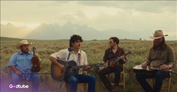 <p>Flatland Calvary recently released a stunning cover of Fleetwood Mac&rsquo;s beloved hit &ldquo;Landslide.&rdquo; The four-member band gives a beautiful tribute to Fleetwood Mac in their cover. Play the video to hear it.&nbsp;</p>

<p>The band covers the song in a beautiful video set in a beautiful field with mountains in the background at sunset, with a microphone, violin, banjo, and two acoustic guitars. They&rsquo;ve chosen a wonderful song to cover. The lead singer&rsquo;s voice perfectly matches the tone of Fleetwood Mac, and the instruments that accompany it are perfection.&nbsp;</p>

<p>Some of the lyrics of &ldquo;Landslide&rdquo; are:&nbsp;</p>

<p>Oh, mirror in the sky, what is love?<br />
Can the child within my heart rise above?<br />
Can I sail through the changing ocean tides?<br />
Can I handle the seasons of my life?</p>

<p>It&rsquo;s a beautiful song about the changes that life brings and getting older. It&rsquo;s incredibly poetic. The &ldquo;landslide&rdquo; seems to imply that life passes by so quickly. The song points out that we think of children as the epitome of youth, but even they get older in the flash of a moment.&nbsp;</p>

<p>It was written by Fleetwood Mac&rsquo;s Stevie Nicks when she was just 27 years old. She says she wrote it in just five minutes while in Aspen, Colorado.&nbsp;</p>

<p>"I did already feel old in a lot of ways," Nicks <a href="https://people.com/fleetwood-mac-landslide-stevie-nicks-true-story-7501550">recalled</a>. "I'd been working as a waitress and a cleaning lady for years. I was tired."</p>

<p>Her struggles inspired her to write that song, and listeners are forever grateful for it.&nbsp;</p>

<p>Flatland Calvary&rsquo;s cover does sweet justice to the original song, and it sounds bittersweet and moving. They have expertly captured the emotional depth of the song and even pay homage to the mountains that inspired it. They show that Nicks&rsquo; &ldquo;Landslide&rdquo; will forever be timeless and tender; that much is certain.</p>
