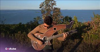 <p>Jamie Dupuis has created a truly beautiful instrumental rendition of &ldquo;Goodness of God&rdquo; on the most unique and beautiful of instruments, a 26-string harp guitar. As he plays, he sits in the wilderness, allowing nature to complement his chords. Play the video to hear the stunning melody!</p>

<p>Jamie&rsquo;s reverent cover of &ldquo;Goodness of God&rdquo; sounds so sweet against the beautiful scenery. He sits on a hilltop next to a blue body of water, cast in sunlight. He has mastered his instrument well. The acoustic chords sound marvelous with the higher-pitched harp-like chords.&nbsp;</p>

<p>&ldquo;This is a worship song and it has one of the most beautiful melodies ever written!&rdquo; Jamie <a href="https://www.youtube.com/watch?v=DsCBJJ7WTqg">said</a>. &ldquo;I hope you enjoy this arrangement on the harp guitar!&rdquo;</p>

<p>We certainly do. This rendition sounds so gentle and peaceful.&nbsp;</p>

<p>If you want to sing along to Jamie&rsquo;s chords, some of the lyrics are:</p>

<p>Your goodness is running after, it's running after me<br />
Your goodness is running after, it's running after me<br />
With my life laid down, I surrendered now<br />
I give You everything</p>

<p>When you think of the song &ldquo;Goodness of God,&rdquo; you may think about its lyrics and the voice that initially sings it, belonging to Jenn Johnson. However, Jamie skillfully brings out the true beauty of the melody of the song through his wonderful rendition. He cleverly and expertly captures the song&rsquo;s essence and message, even without the lyrics present.&nbsp;</p>

<p>His video is a soul-stirring experience that is sure to give you a peaceful and grateful feeling for God&rsquo;s goodness. Surrounded by nature, the song is a quiet praise carried in the wind, full of reflection, wonder, and peace.&nbsp;</p>

<p><em>&ldquo;Every good gift and every perfect boon is from above, coming down from the Father of lights, with whom can be no variation, neither shadow that is cast by turning.&rdquo; <strong><a href="https://www.godtube.com/bible/james/1-17">James 1:17</a></strong></em></p>
