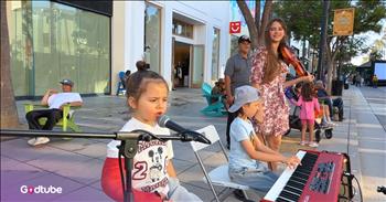 <p>Prepare to be amazed by precious little ones. This street performance will have you smiling today. This tiny performer steals hearts with adorable 'L-O-V-E.' Rendition.</p>

<p>As this video begins, a little girl introduces herself alongside her brother and sister. She invites a street crowd to listen to her song. The girl says her name very professionally and reveals that she is only 4 years old. She has such confidence and calm in front of a crowd.&nbsp;</p>

<p>The eldest sister is a famous violin dancer named Karolina Protsenko. You see the brother is doing a great job on the piano for his age, and the little girl is a fantastic singer. As the sweet girl sings, sitting there with a broken arm and a precious face, the crowd is in awe.&nbsp;</p>

<p>She is only four, and she is singing out these lyrics with such poise. It is a lot of work to simply learn the words to the song, and to also learn the melody, and this precious girl does both!</p>

<p>This classic hit says:</p>

<p>Two in love can make it<br />
Take my heart and please don't break it<br />
Love was made for me and you</p>

<p>God created all types of music genres. It is refreshing to hear young people singing timeless songs from previous decades. You will be wholly immersed in what this young preschooler sings. The audience is delighted by her sharing this moment with them, and it is fun being a &ldquo;fly on the wall.&rdquo;&nbsp;</p>

<p>As believers in Jesus, we know that He is love. He tells us that He is perfect love. As we reflect on this song, which speaks of the gift of love, may it point us upward to His eternal love for us. May we love others well today because of His love for us.<br />
&nbsp;<br />
<em>&ldquo;Whoever does not love does not know God, because God is love.&rdquo; <strong><a href="https://www.godtube.com/bible/1-John/4-8">1 John 4:8</a></strong></em></p>
