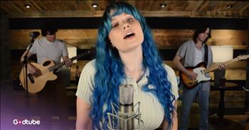 <p>This incredible new cover of &lsquo;(Sittin&rsquo; On) The Dock of the Bay&rsquo; will have you floating towards Christmas break in no time. There are days in December when time doesn&rsquo;t walk&mdash;it sprints. And we moms are right there chasing it, ponytail flying, coffee going cold, calendar notifications popping like popcorn.&nbsp;</p>

<p>Concerts. School projects that somehow require glitter at 9 p.m. Sports events layered on top of Christmas programs.&nbsp;</p>

<p>Cards to mail. Cookies to bake. Volunteering to volunteer for volunteering. It&rsquo;s beautiful and exhausting and loud in the way only a full life can be.</p>

<p>And then a song stops you.</p>

<p>IMY2&rsquo;s take on &ldquo;(Sittin&rsquo; On) The Dock of the Bay&rdquo; drifts in, and suddenly your shoulders drop an inch. Maybe two. The song we&rsquo;ve known forever is reimagined&mdash;soft but strong, familiar yet fresh&mdash;and it feels like someone gently reminding us how to breathe again.</p>

<p><a href="https://www.youtube.com/channel/UCbApf9P470ReY3sEQ2FWHcA">IMY2</a> is a three-piece pop/rock group based in Nashville, Tennessee, known for blending original music with thoughtful covers of well-loved classics. At the center is Annalise Mahanes, lead vocalist and primary songwriter, whose voice somehow feels both grounded and wild at the same time. She&rsquo;s joined by Cal Tucker on bass and piano and Michael Monahan on guitar, and together they don&rsquo;t just play songs&mdash;they hold them.</p>

<p>Watching Annalise sing is its own experience. Her blue hair alone deserves a moment of silence. Or applause. Or at least a pause where you ask yourself, Could I pull that off?&nbsp;</p>

<p>You imagine it for half a second, blue hair, oversized sweater, no responsibilities beyond sipping something warm and staring at water. And then reality taps you on the shoulder and reminds you that you have a permission slip due tomorrow and someone needs clean socks.</p>

<p>Still, a mom can dream.</p>

<p>IMY2&rsquo;s version of &lsquo;Dock of the Bay&rsquo; feels like an invitation to that dream. It&rsquo;s unhurried. Unbothered. The opposite of the mental to-do list currently running laps in your head. It makes you long for a dock somewhere&mdash;anywhere&mdash;where no one needs you to sign, glue, drive, organize, or remember the difference between festive casual and Christmas formal.</p>

<p>The irony, of course, is that we&rsquo;re listening to this song while folding laundry or sitting in the carpool line, surrounded by backpacks and half-eaten snacks. Our docks are minivans. Our bays are calendars. We&rsquo;re not sitting&mdash;we&rsquo;re sprinting. But for three minutes and some change, the song lets us pretend.</p>

<p>So we keep moving. We keep showing up. We keep wrapping gifts and snacks and ourselves in grace. But maybe tonight, after the last light is turned off and the house finally exhales, we sit for a minute. Headphones in. Song on repeat.</p>

<p>Just sitting on the dock of the bay&mdash;Watching the mom-life roll away.</p>
