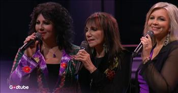 <p>Prepare to be amazed and join in with this moment of live worship music. Watch The Isaacs&rsquo; &lsquo;Agnus Dei&rsquo; dazzling live performance.</p>

<p>The song begins with a beautiful guitar solo. The instrumental introduction leads into this trio, featuring their stunning harmonies, and culminates in the chorus of &ldquo;Agnus Dei.&rdquo; These incredible voices all come together alongside talented musicians in a huge auditorium.&nbsp;</p>

<p>The lights are dimmed down low with purple spotlights. The women sing together with such poise and posture of worship.&nbsp;</p>

<p>As you listen, you will feel a sense of peace, worship, and awe. These timeless lyrics lead us into vertical adoration of the only One who is holy. There are wonderful moments of the violinist playing, as well as highlights from each vocalist. These women have taken great care of their voices over the years and sound phenomenal.&nbsp;</p>

<p>The chorus says:</p>

<p>Holy, holy<br />
Are You, Lord God Almighty<br />
Worthy is the Lamb<br />
Worthy is the Lamb<br />
You are holy, holy</p>

<p>What makes this moment extra special and unique is that this is a mother singing beside her daughters. This family sings so well together and appears to be having a great time. Their tones blend beautifully, and their harmonies are unexpected and delightful. You can tell throughout the song that this is a precious moment for this family.&nbsp;</p>

<p>Perhaps you are not on a stage performing beside your loved ones, but God has brought you into the family or community that you are in for the same purpose, to glorify Him. Many times, this is sung at Christmas time in memory of the Christmas story and John the Baptist, who prepared the way for the Lamb of God, the Agnus Dei. As you reflect on Jesus&rsquo; sacrifice, may you be in awe of His great love through this precious family.</p>

<p><em>&ldquo;The next day John saw Jesus coming toward him and said, &ldquo;Look, the Lamb of God, who takes away the sin of the world!&rdquo; <strong><a href="https://www.godtube.com/bible/John/1-29">John 1:29</a></strong></em></p>
