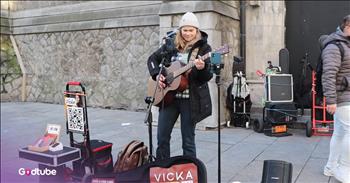 <p>This busker&rsquo;s take on Elvis&rsquo; Classic &ldquo;Suspicious Minds&rdquo; is stunning. Young artist Vicka brings a little bit of majesty and wonder to a Dublin street square in this Elvis cover. Play the video to step into the moment.&nbsp;</p>

<p>Vicka is an absolutely wonderful artist. If I were walking along a busy street, I would stop in my tracks if I heard her lovely voice singing. And many turn their heads to listen to Vicka as they walk by.&nbsp;</p>

<p>She&rsquo;s an absolutely incredible artist, and she&rsquo;s expertly chosen a unique song to sing, which she&rsquo;s made beautiful with her special musical talents. Her voice is gentle, beautiful, and powerful. Her guitar playing is spot-on, too.&nbsp;</p>

<p>Some of the <a href="https://genius.com/Elvis-presley-suspicious-minds-lyrics">lyrics</a> she sings are:&nbsp;</p>

<p>Oh, let our love survive<br />
I'll dry the tears from your eyes<br />
Let's don't let a good thing die<br />
When, honey, you know I have never lied to you, mm</p>

<p>It is a beautiful moment on the street to hear the young artist amidst the hustle and bustle. It serves as a reminder to stop and appreciate the beauty around you.&nbsp;</p>

<p>It&rsquo;s impressive how Vicka lends her own style to the classic Elvis song. If you weren&rsquo;t already familiar with the song, you&rsquo;d probably never guess that she&rsquo;s singing an Elvis original, because it sounds all her own.&nbsp;</p>

<p>As people rush by her to run their errands, she creates a lovely little atmosphere of calmness and emotion. She somehow commands attention without overtly asking for it. It&rsquo;s like she&rsquo;s meant to create in this setting, this space.&nbsp;</p>

<p>Vicka&rsquo;s performance is sincere and heartfelt. She doesn&rsquo;t have anything flashy to draw attention&mdash;just her guitar and her voice. I&rsquo;m sure those who open their ears and hearts to listen will thoroughly enjoy this moment she creates.</p>

