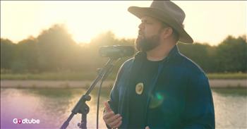 <p>Some songs feel like memory itself. And when someone sings one of those songs with care and reverence, it feels like a gift, like this beautiful country cover of &lsquo;Can&rsquo;t Help Falling In Love&rsquo; by Sheridan Brass.&nbsp;</p>

<p>You know how certain songs just stay with us? Not because they&rsquo;re loud or dramatic, but because they become part of our story &mdash; they play at weddings, on long drives, or in quiet moments when our hearts feel full or tender.</p>

<p>Sheridan recently released his country-style version of Elvis Presley&rsquo;s classic, and it&rsquo;s one of those performances you want to tell someone about. Not because it&rsquo;s full of glitz and glamour, but because it takes you back into your memories. It&rsquo;s the kind of song that makes you sit still for a minute.</p>

<p>The video was filmed at Love Lake, located on the outskirts of Dubai &mdash; a serene, open countryside space with water, soft light, and a wide sky. Sheridan stands there in boots and a cowboy hat, singing as if he&rsquo;s offering the song instead of performing it.</p>

<p>He <a href="https://www.youtube.com/watch?v=YJ-RQI5gHNE">wrote</a>, &ldquo;Some songs don&rsquo;t just live in time &mdash; they live in the moments we attach to them. This one felt special to revisit, stripped back and honest, letting the melody and words do what they&rsquo;ve always done best.&rdquo;</p>

<p>He <a href="https://www.youtube.com/watch?v=YJ-RQI5gHNE">said</a> he chose Love Lake because it felt right for a song about &ldquo;inevitability, love, and surrender.&rdquo;</p>

<p>And that&rsquo;s how it feels when you listen. Like something being gently placed in your hands.</p>

<p>People felt that, too. &ldquo;I&rsquo;ve always loved Elvis&rsquo;s version of this song, and hearing you sing it makes it even more special,&rdquo; one listener <a href="https://www.youtube.com/watch?v=YJ-RQI5gHNE">wrote</a>. &ldquo;We love you, Sheridan. Happy New Year.&rdquo;</p>

<p>Another <a href="https://www.youtube.com/watch?v=YJ-RQI5gHNE">shared</a>, &ldquo;Every track you drop carries that magic&hellip; all your songs have this unique feel no one else even comes close to.&rdquo;</p>

<p>And one simply <a href="https://www.youtube.com/watch?v=YJ-RQI5gHNE">said</a>, &ldquo;Thank you, Sheridan, you are blessed to have a voice like this.&rdquo;</p>

<p>Isn&rsquo;t that lovely?</p>

<p>He even <a href="https://www.youtube.com/watch?v=YJ-RQI5gHNE">wrote</a>, &ldquo;If this song means something to you, I hope this version finds its way into your moment.&rdquo;</p>

<p>I think that&rsquo;s what makes this so beautiful. It&rsquo;s not just music. It&rsquo;s an offering. A reminder that love isn&rsquo;t something we rush or force &mdash; it&rsquo;s something we receive.</p>

<p>It&rsquo;s the quiet yes.<br />
The gentle falling.<br />
The kind of love that feels safe instead of loud.</p>

<p>And sometimes, that&rsquo;s exactly what our hearts need to hear.</p>

<p><em><strong><a href="https://www.godtube.com/bible/song-of-solomon/8-7">Song of Songs 8:7</a></strong> &ldquo;Many waters cannot quench love; rivers cannot sweep it away.&rdquo;</em></p>
