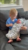 Fergus meeting his little brother, Remy, for the first time.