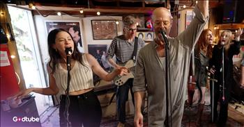 <p>You&rsquo;ll want to watch this as the Middle Aged Dad Jam Band blends &lsquo;Turn the Beat Around&rsquo; with &lsquo;Rock the Casbah.&rsquo; There was a time when music wasn&rsquo;t something we fit into the margins of our lives &mdash; it was our life.</p>

<p>It was the soundtrack of car rides with the windows down, of bedrooms with posters on the walls, of late nights with friends where nobody checked the clock because nobody had anywhere they had to be in the morning. Music was loud and unapologetic and woven into who we were becoming.</p>

<p>We didn&rsquo;t listen to songs back then. We lived inside them. We knew every word. Every drum beat. Every dramatic pause before the chorus dropped. We sang like nobody was listening because nobody important was.</p>

<p>And then&hellip; well. We grew up.</p>

<p>We got jobs and kids and meetings and laundry and back pain and grocery lists and calendars that beep when it&rsquo;s time to switch the laundry over. Somewhere between paying bills and refilling prescriptions, we forgot what it felt like to just be a person with a favorite song again.</p>

<p>Not a mom. Not a dad. Not a manager or a chauffeur or a responsible adult. Just a person who really, really loved that one song. Which is why the Middle Aged Dad Jam Band feels like such a gift.</p>

<p>If you haven&rsquo;t heard of them yet, their name alone already makes you smile. The Middle Aged Dad Jam Band &mdash; or MADJB for short &mdash; is exactly what it sounds like: a group of middle-aged guys who decided that growing older doesn&rsquo;t mean growing quieter.</p>

<p>The band was started by Ken Marino and David Wain, along with a revolving cast of friends and guest musicians, and their entire mission is joy. They mash up iconic songs, blend genres that have no business being together, and sprinkle comedy between the music like confetti.</p>

<p>They&rsquo;ll take &ldquo;Turn the Beat Around&rdquo; and slide it right into &ldquo;Rock the Casbah,&rdquo; and somehow it works in a living-room-dance-party way. In a &ldquo;this feels ridiculous and wonderful and I love it&rdquo; kind of way.</p>

<p>It&rsquo;s part concert, part comedy show, part midlife permission slip. Permission to sing again. Permission to be goofy again. Permission to love the music you love without explaining it to anyone.</p>

<p>Maybe that&rsquo;s the gift of the Middle Aged Dad Jam Band &mdash; not just the music, but the reminder. That joy still fits inside grown-up lives. That it&rsquo;s okay to laugh loudly, sing badly, and love what you love. And that the best soundtrack might not be behind us after all.</p>

<p><em>&ldquo;Sing to the Lord a new song; sing to the Lord, all the earth.&rdquo; &nbsp;<strong><a href="https://www.godtube.com/bible/psalms/96-1">Psalm 96:1</a></strong></em></p>
