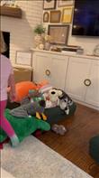 Olive being buried in her toys.