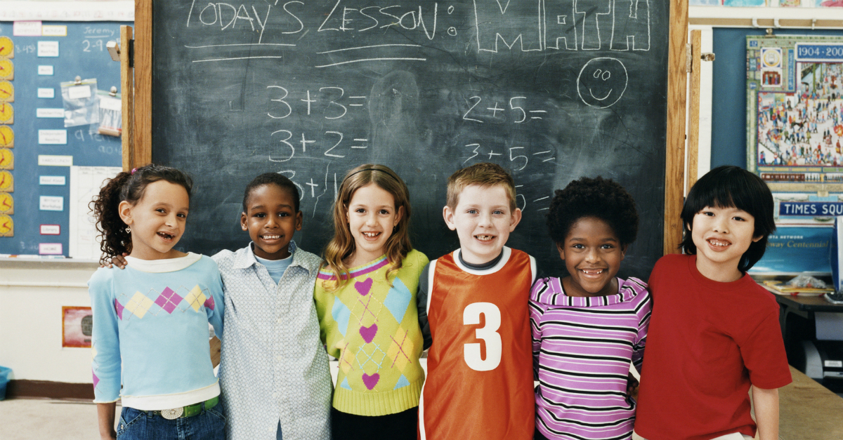 multicultural kids standing together in front of blackboard, insights on inclusion from educator