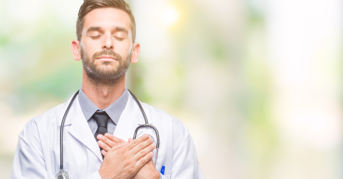 Doctor closing eyes in prayer