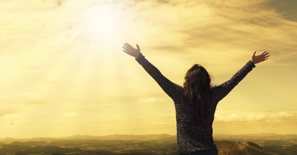 Woman with arms raised in worship and praise