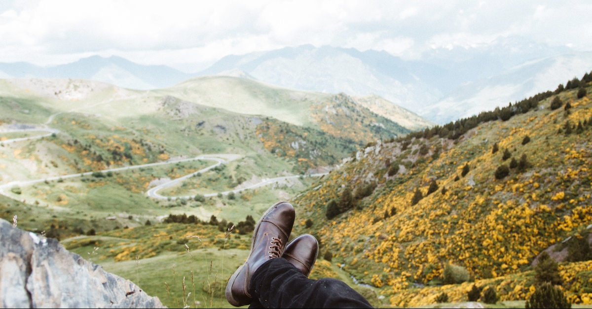 Feet crossed looking over a mountain view