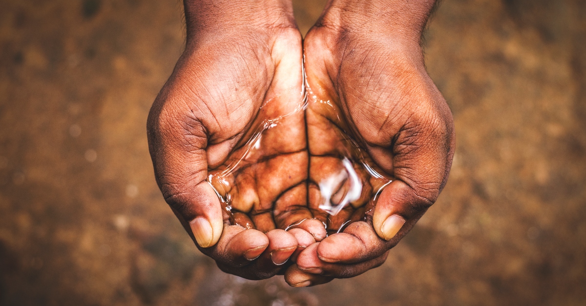 cupped hands holding water, satisfied in god