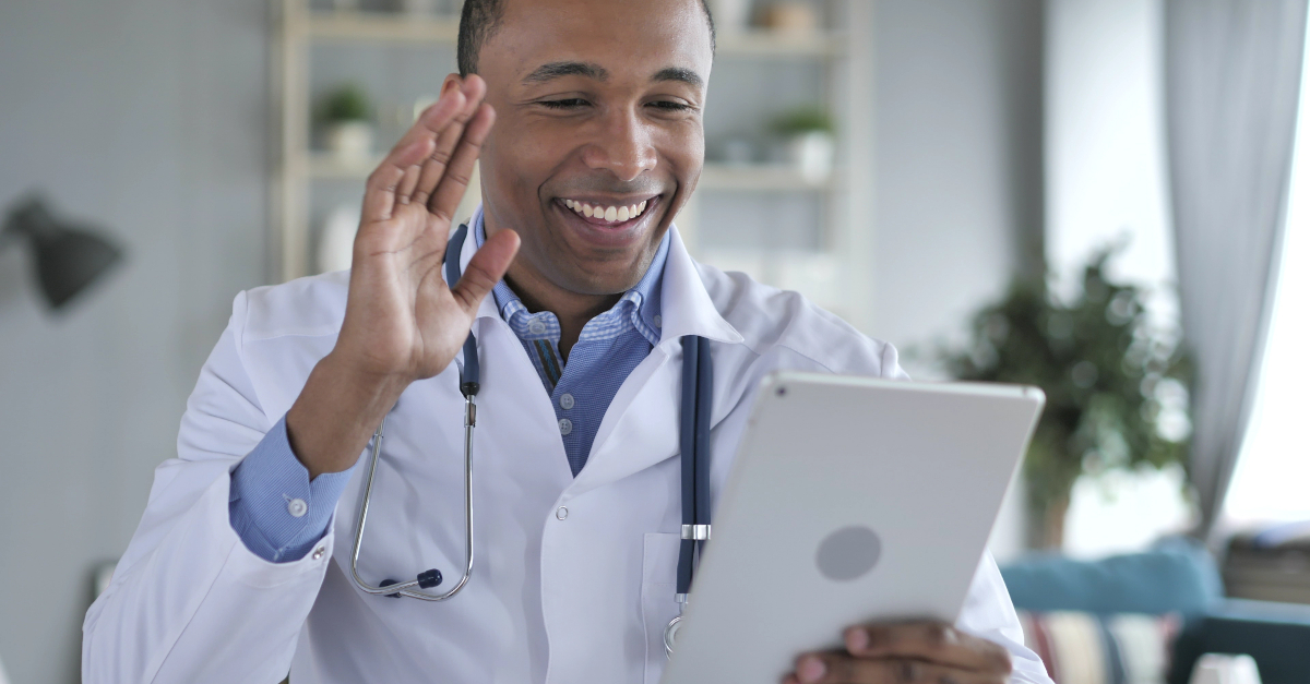 doctor holding ipad conducting a telehealth virtual doctor visit