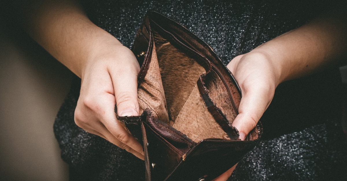 Woman holding open an empty wallet