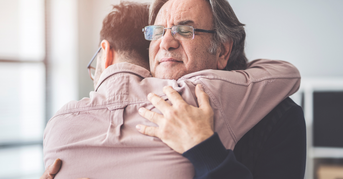 Adult son hugs dad Father's Day forgiveness