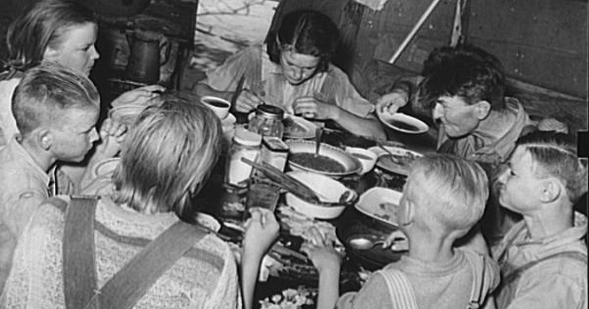 great depression family dinner table black and white photo