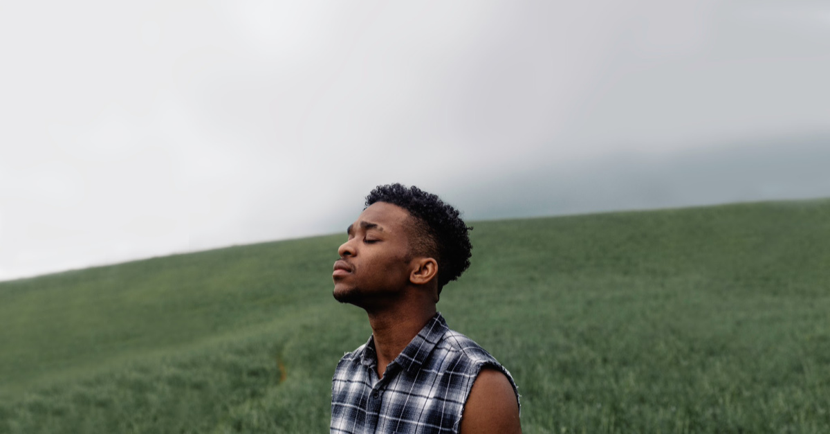 A young black man praying