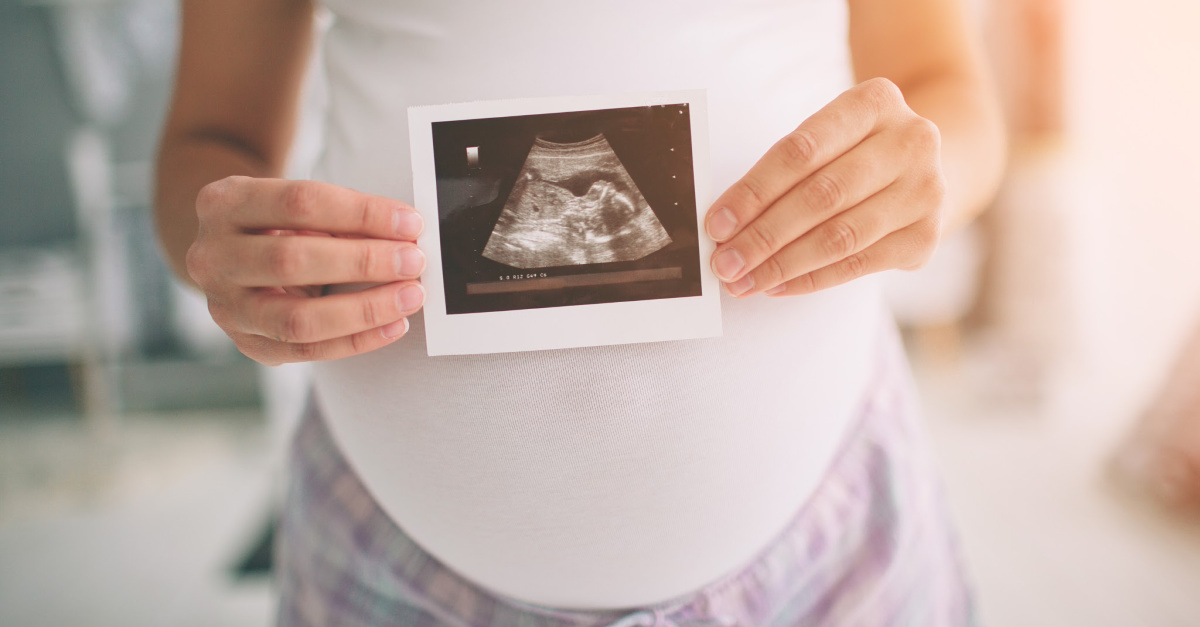 A pregnant woman, A federal court upholds pro-life law stating that life begins at conception