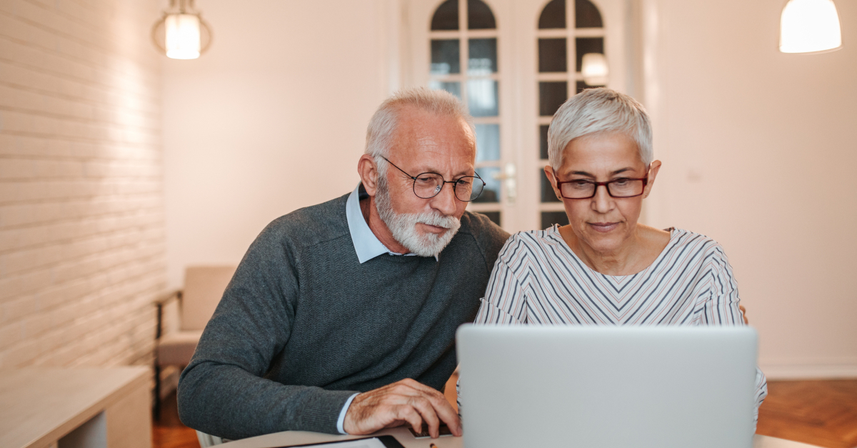 senior couple looking at laptop planning finances