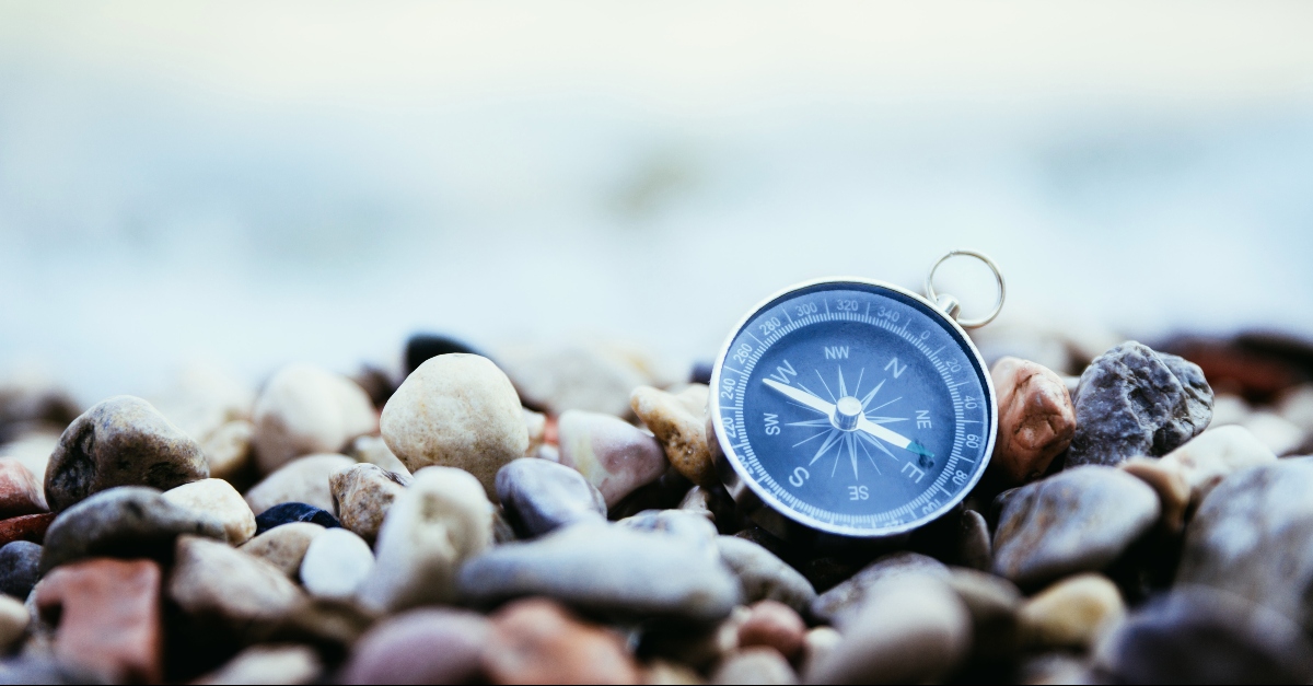 Compass on a stony beach, god is good all the time