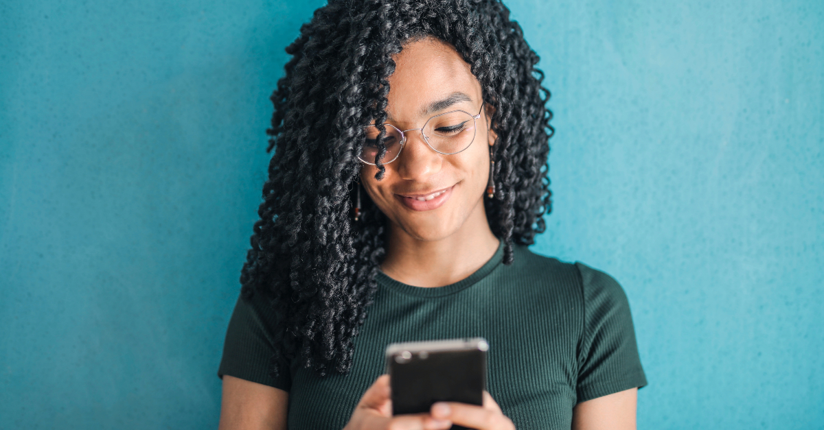 woman smiling looking at smartphone social media