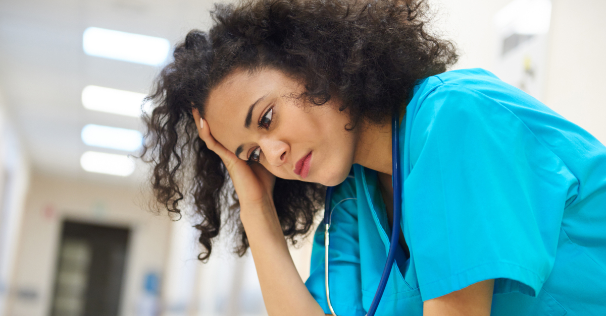 nurse in hospital hall worried stressed anxious