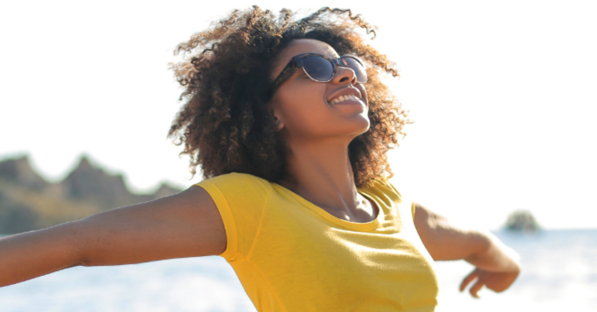 woman face up to sun outdoors in joyful praise