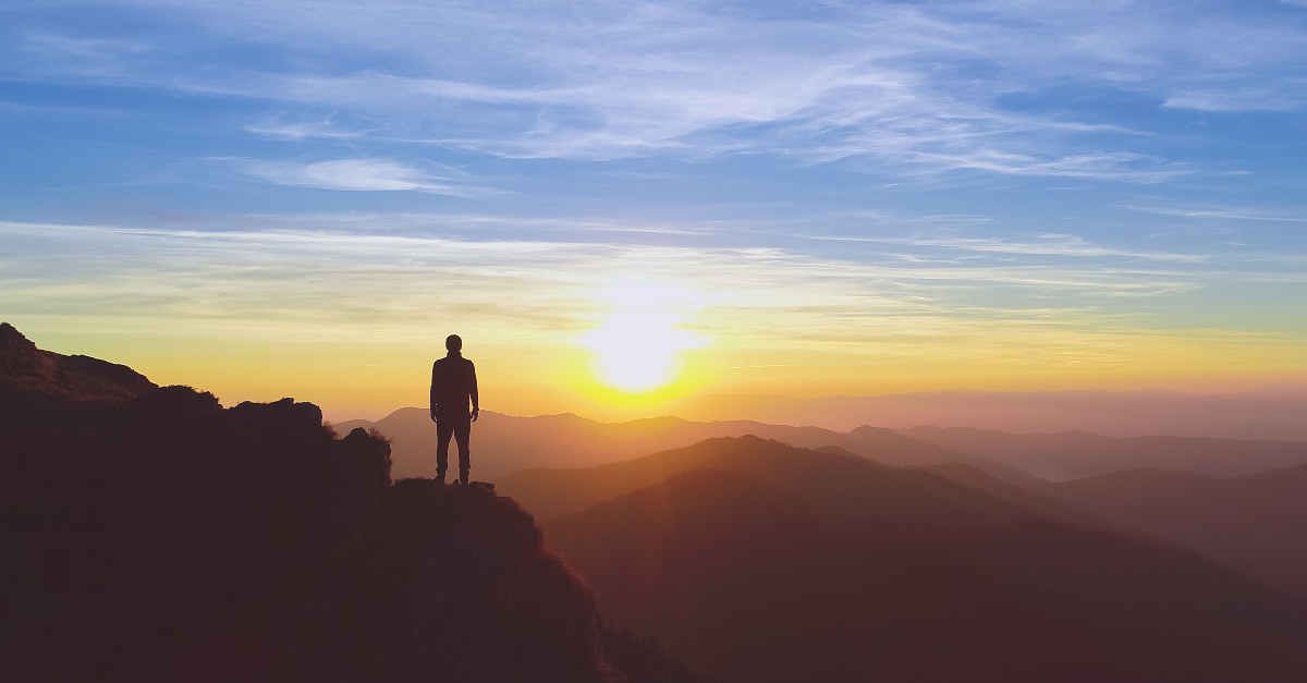 man gazing at sunset on mountaintop psalms for comfort