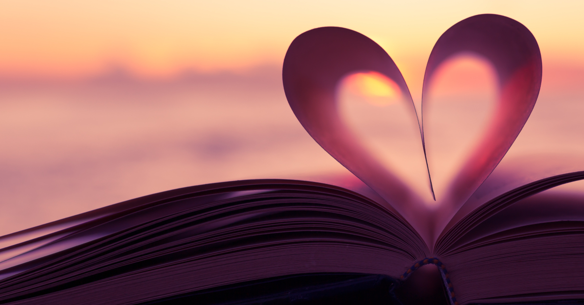 open book with pages folded into heart shape at sunset healing