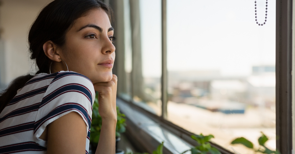young woman looking wistfully out a window, for those who havent done great things for God