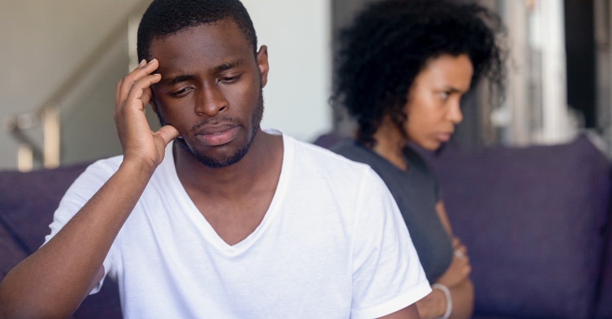 married couple looking away from each other looking upset, loving someone when they're angry