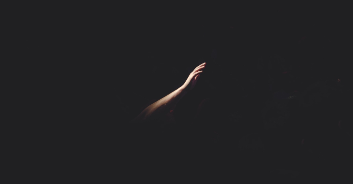 hand reaching out in darkness, how to move beyond shame into active love