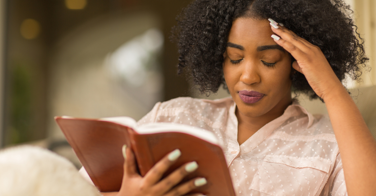 woman upset reading bible