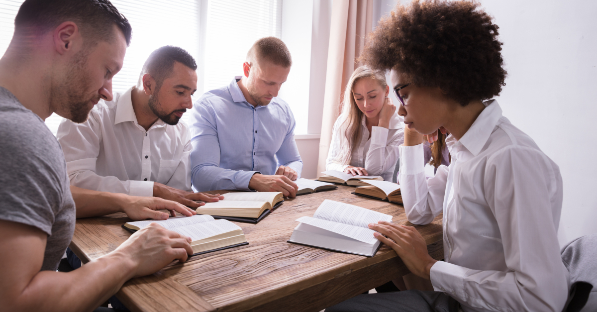 Diverse group of adults seriously studying the Bible