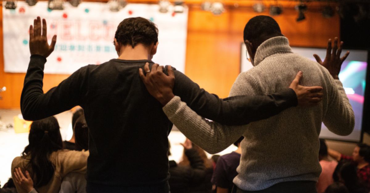 A white and a black man praying together, how Christians can make a difference in bringing about racial unity