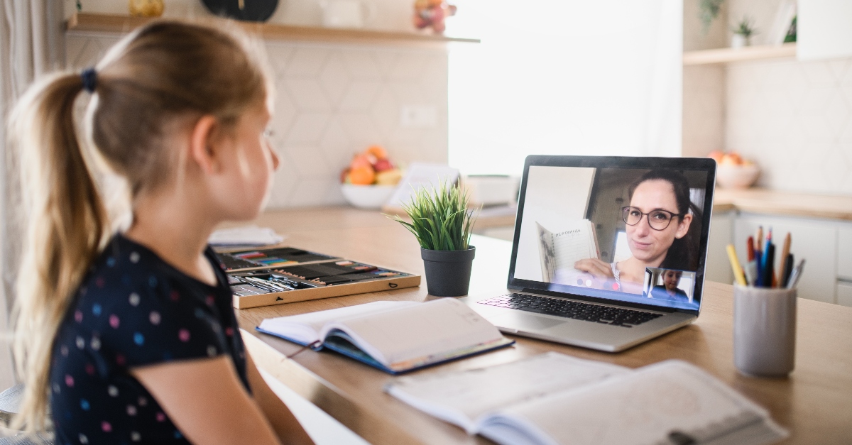 student girl sitting in front of computer with teacher teaching in classroom, challenges teachers facing covid