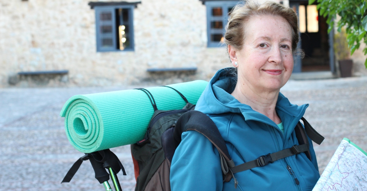 senior woman hiking in European town in retirement