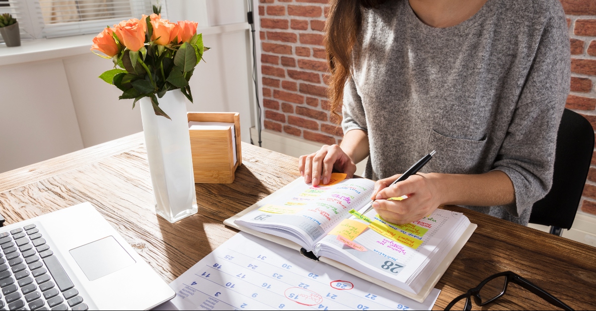 Woman making plans in day planner