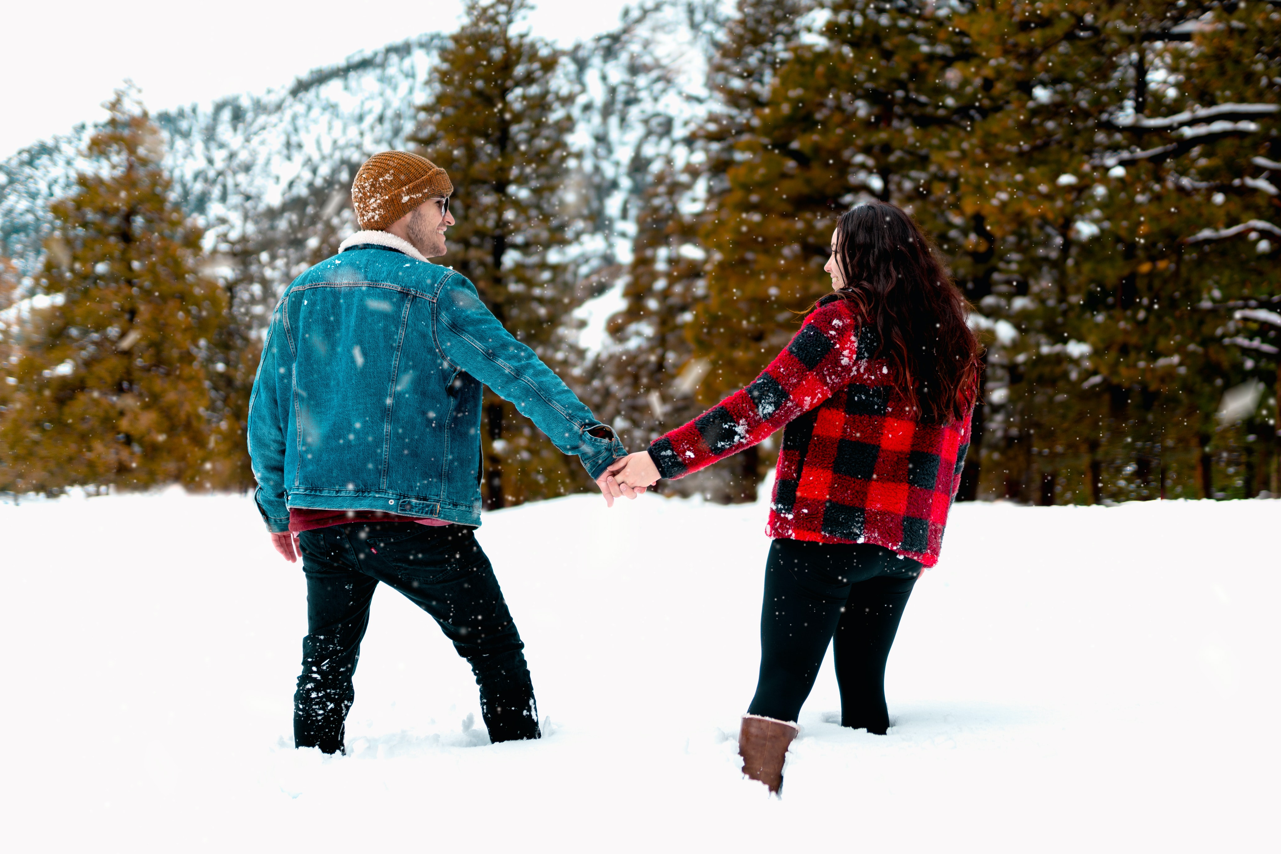 couple walking in snow sharing the gift of time at Christmas