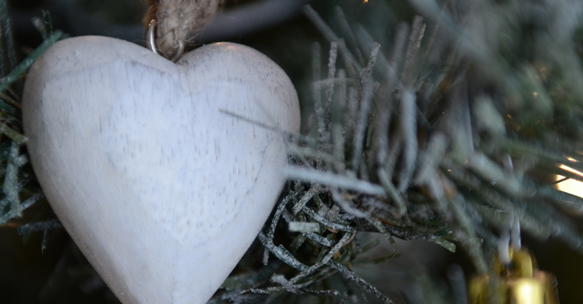 closeup of white wooden heart handmade christmas tree ornament