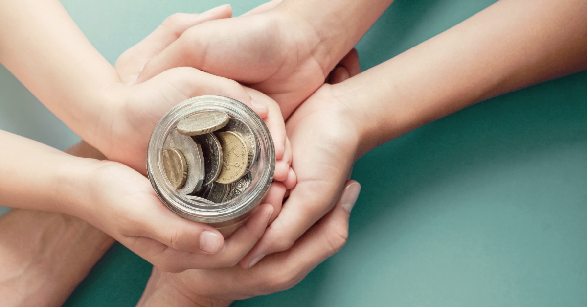 Many hands holding a jar of coins