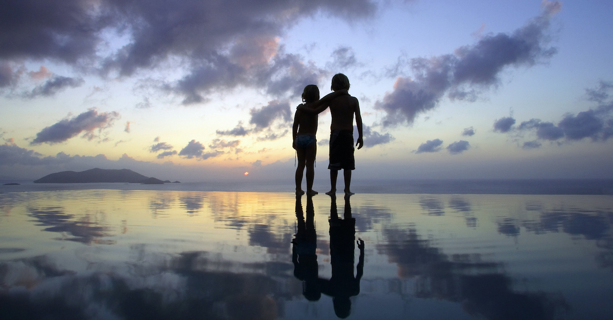 Two children with arms resting on each others shoulders on the beach at sunset, did Jesus have half-siblings?