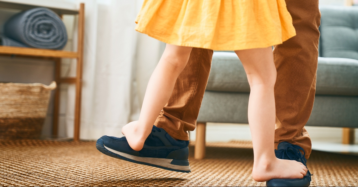 Daughter dancing on her fathers feet