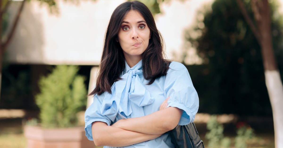 woman outside arms crossed upset angry questioning