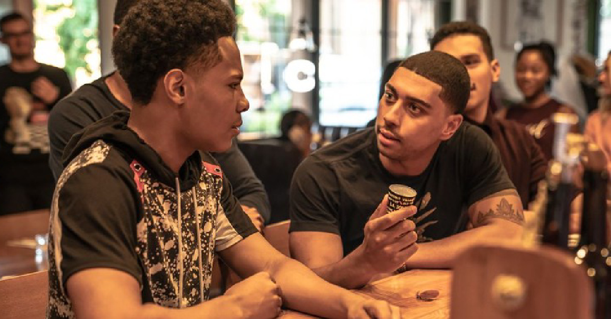 Two young men talking in a cafe in Freshman Year