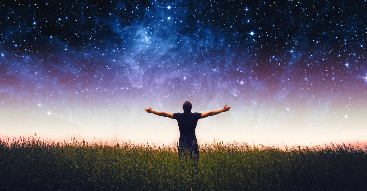 Man standing under a star-studded sky