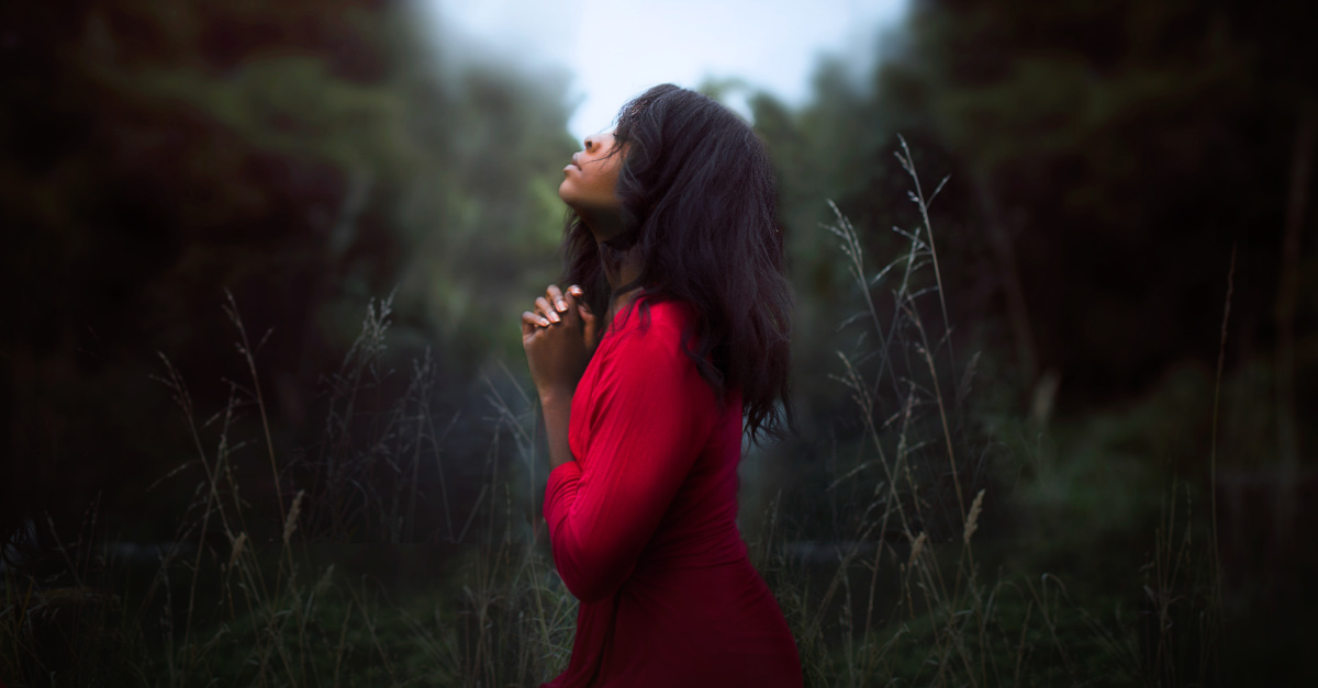 a woman praying outside