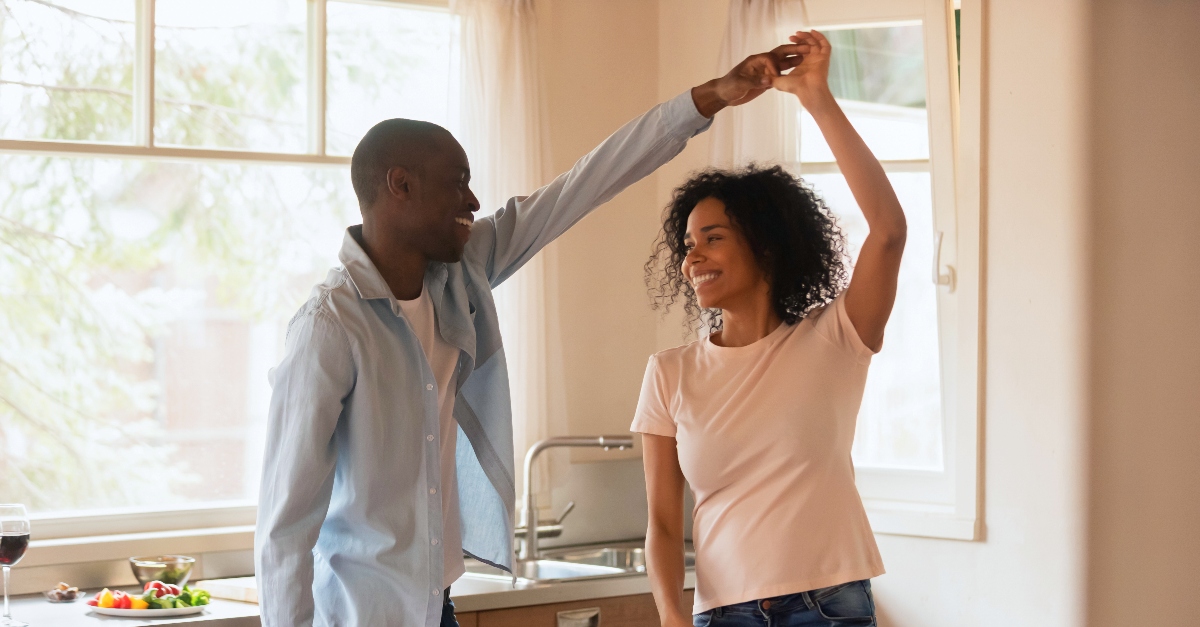 Husband and wife dancing in the kitchen