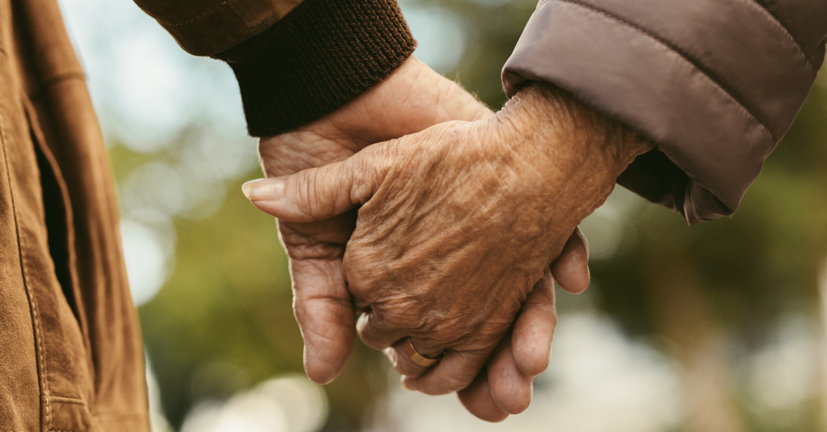 Elderly couple holding hands, couple celebrates 70 years of marriage and thanks God