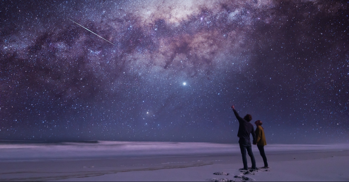 Couple pointing to the stars