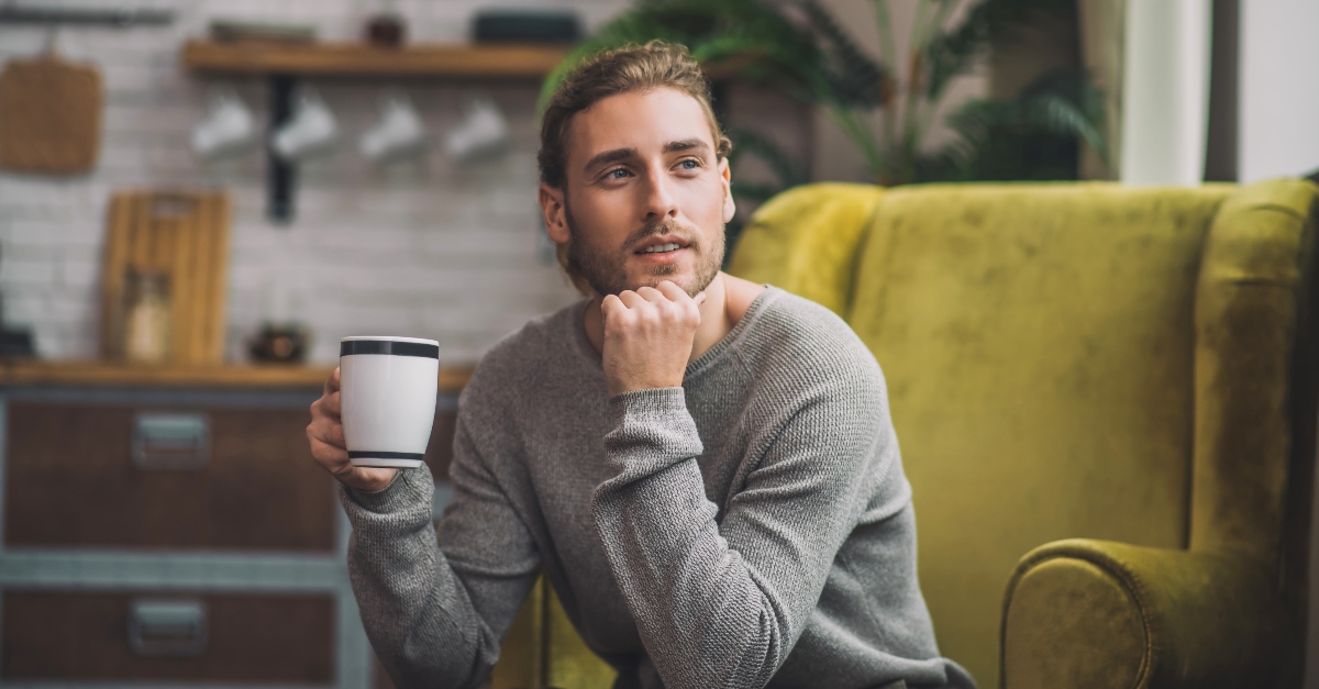 Man contemplating with a cup of coffee